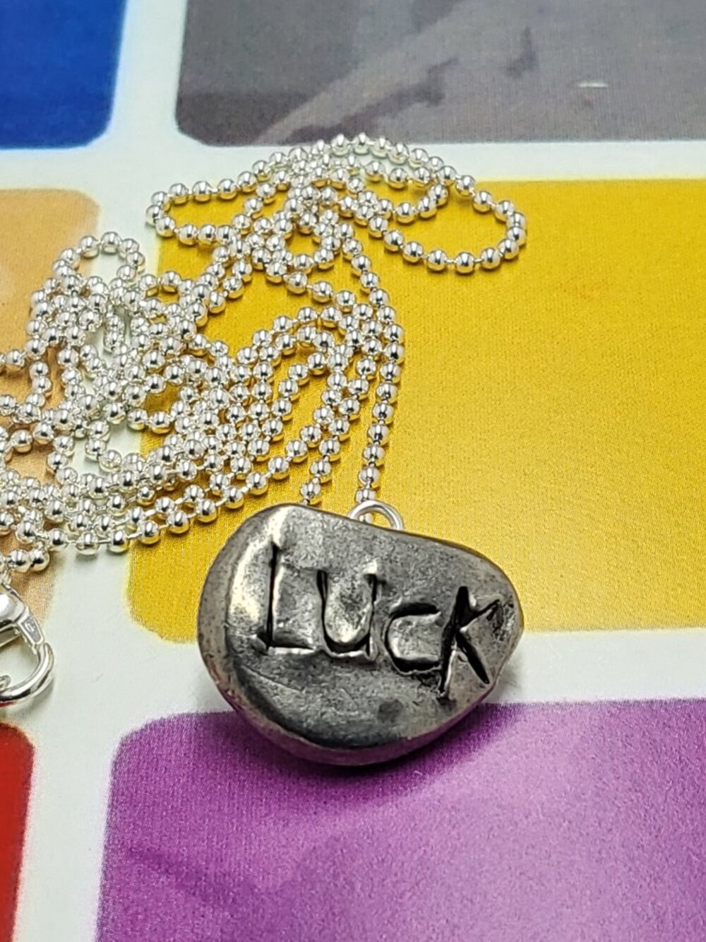 Necklace vintage Todd Oldham Button 90s Silver tone LUCK carving lucky pebble